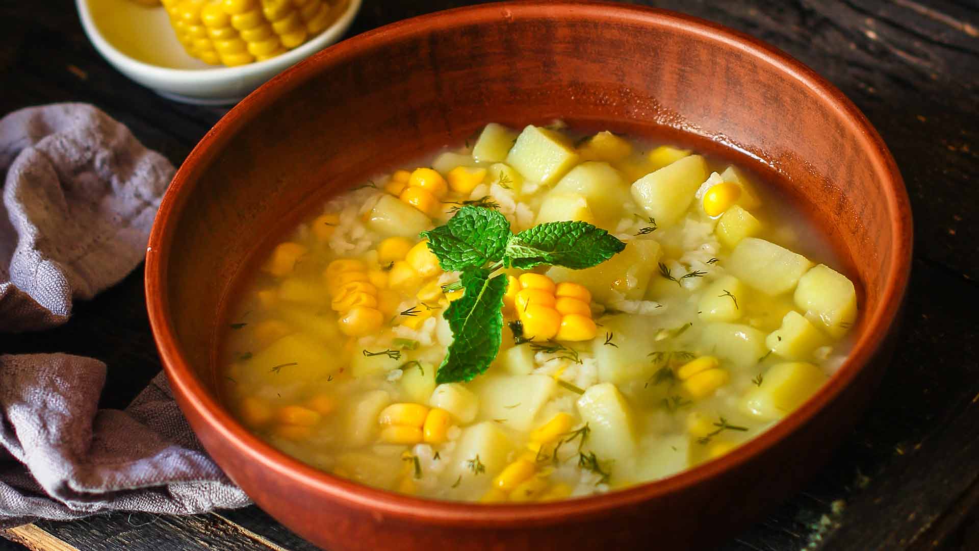 Sweet Corn Celery Soup in a bowl with corn placed in table